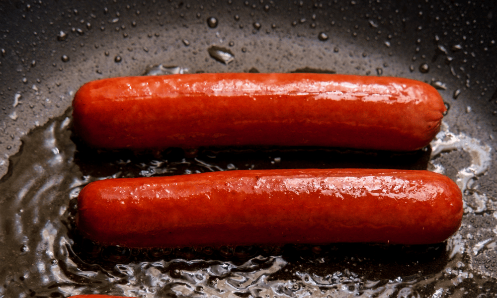 Reheating Hot Dogs in a Black Pan with Oil