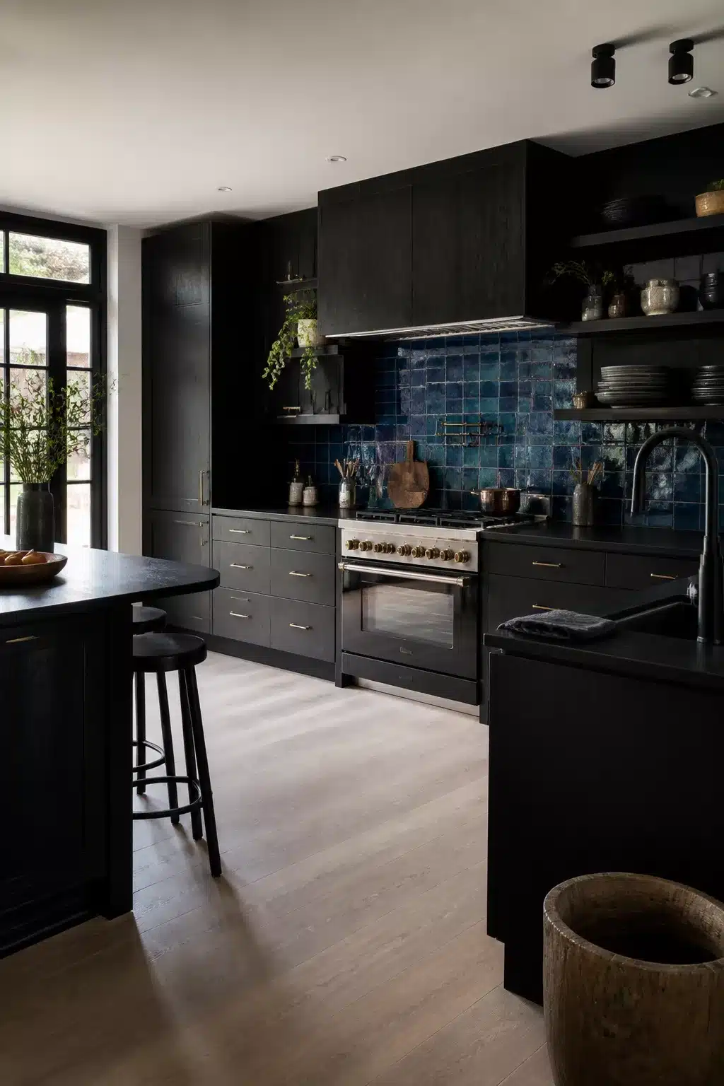 Black kitchen aesthetic ideas with dark cabinetry and deep teal blue zellige tile backsplash