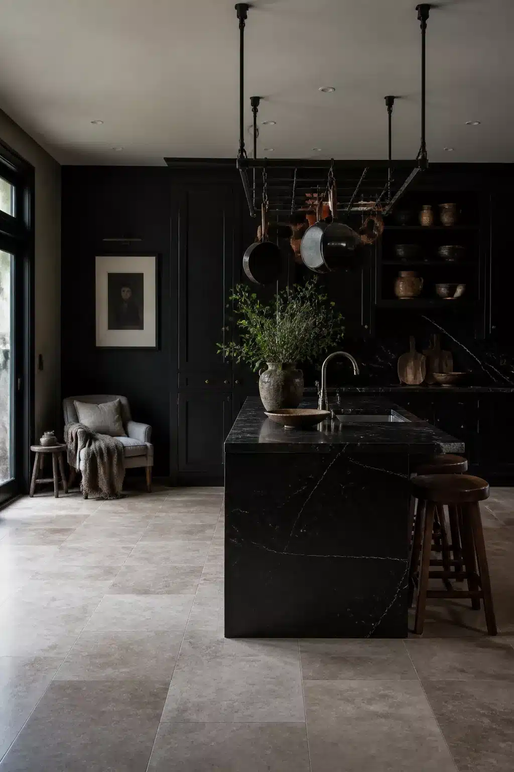 Black kitchen aesthetic ideas with black marble waterfall island, dark cabinetry, and large-format stone tile floor