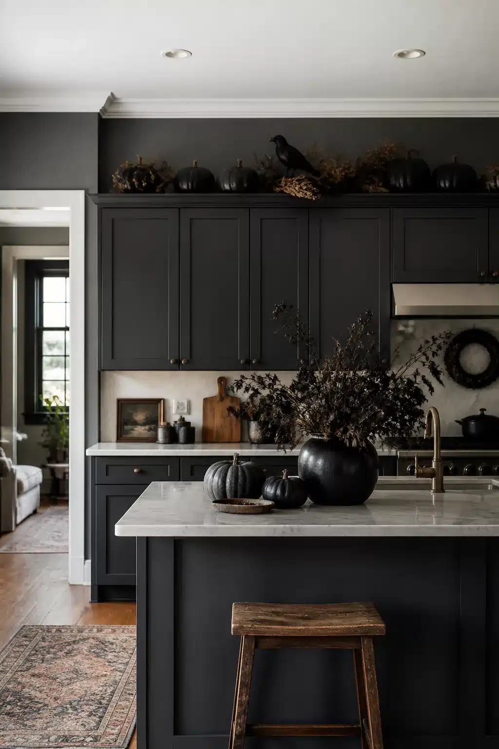 Gothic fall kitchen cabinet decor with matte black pumpkins, faux raven, dried botanicals & dark charcoal cabinets