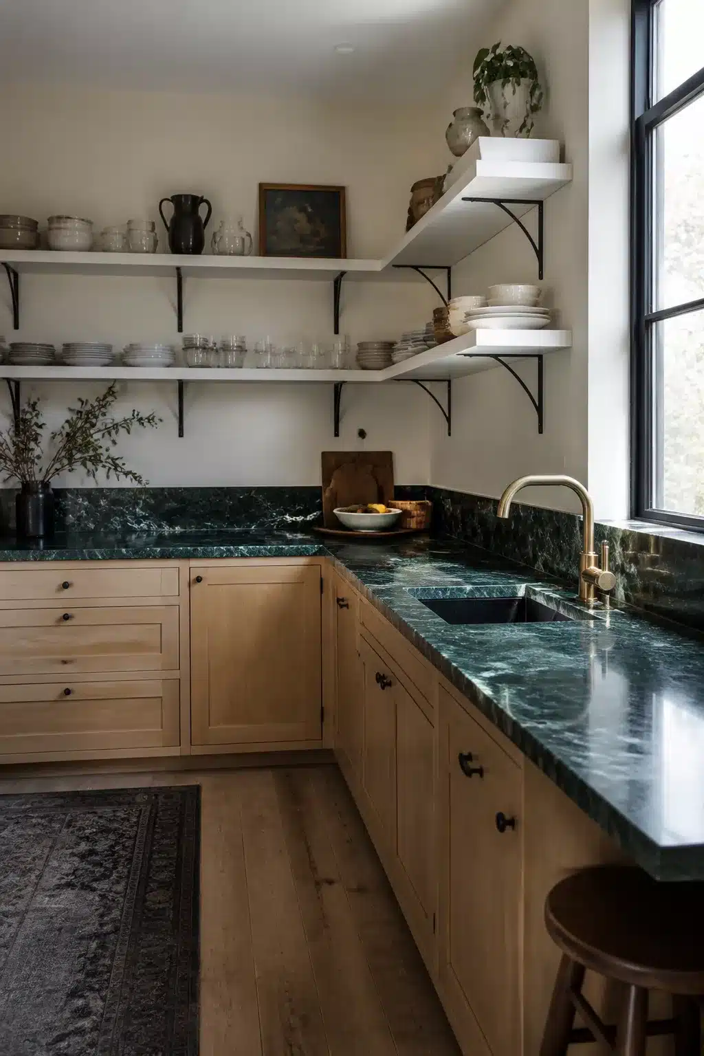 Verde Alpi green kitchen countertops with natural oak cabinets and open white shelving displaying ceramics