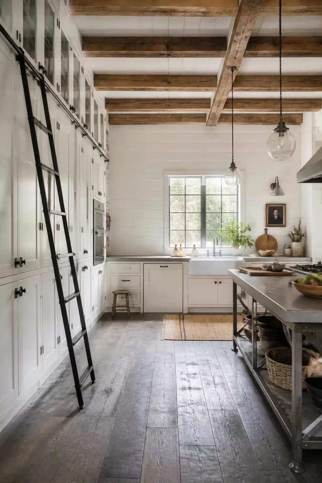 Floor-to-ceiling white pantry cabinets with rolling black metal ladder in an industrial farmhouse kitchen