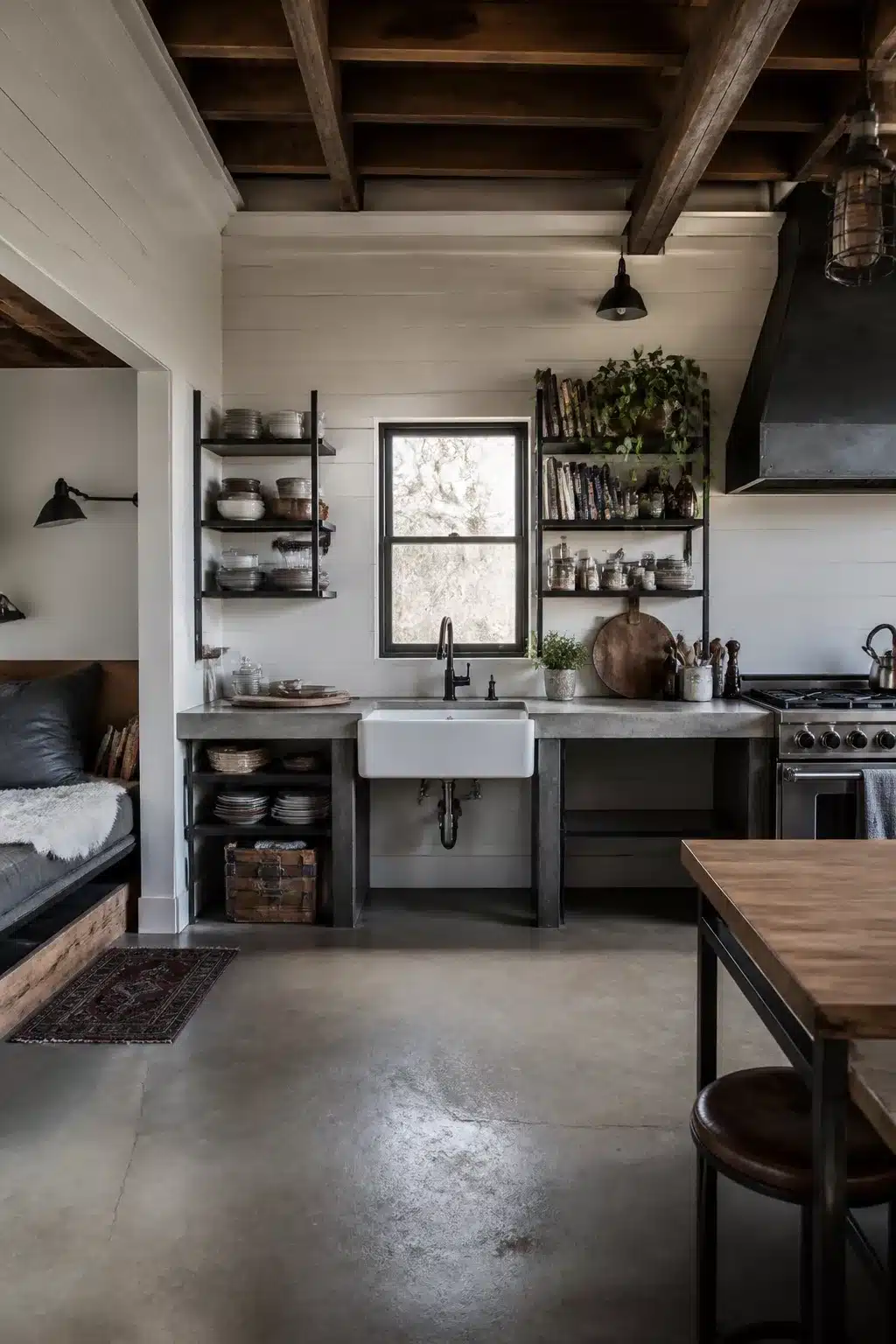 Industrial farmhouse kitchen with shiplap walls, exposed wood beams, concrete countertops, and polished concrete floors