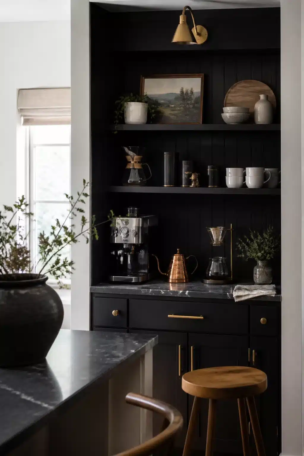 Matte black kitchen coffee bar corner decor ideas with brass sconce, open shelves, and copper kettle