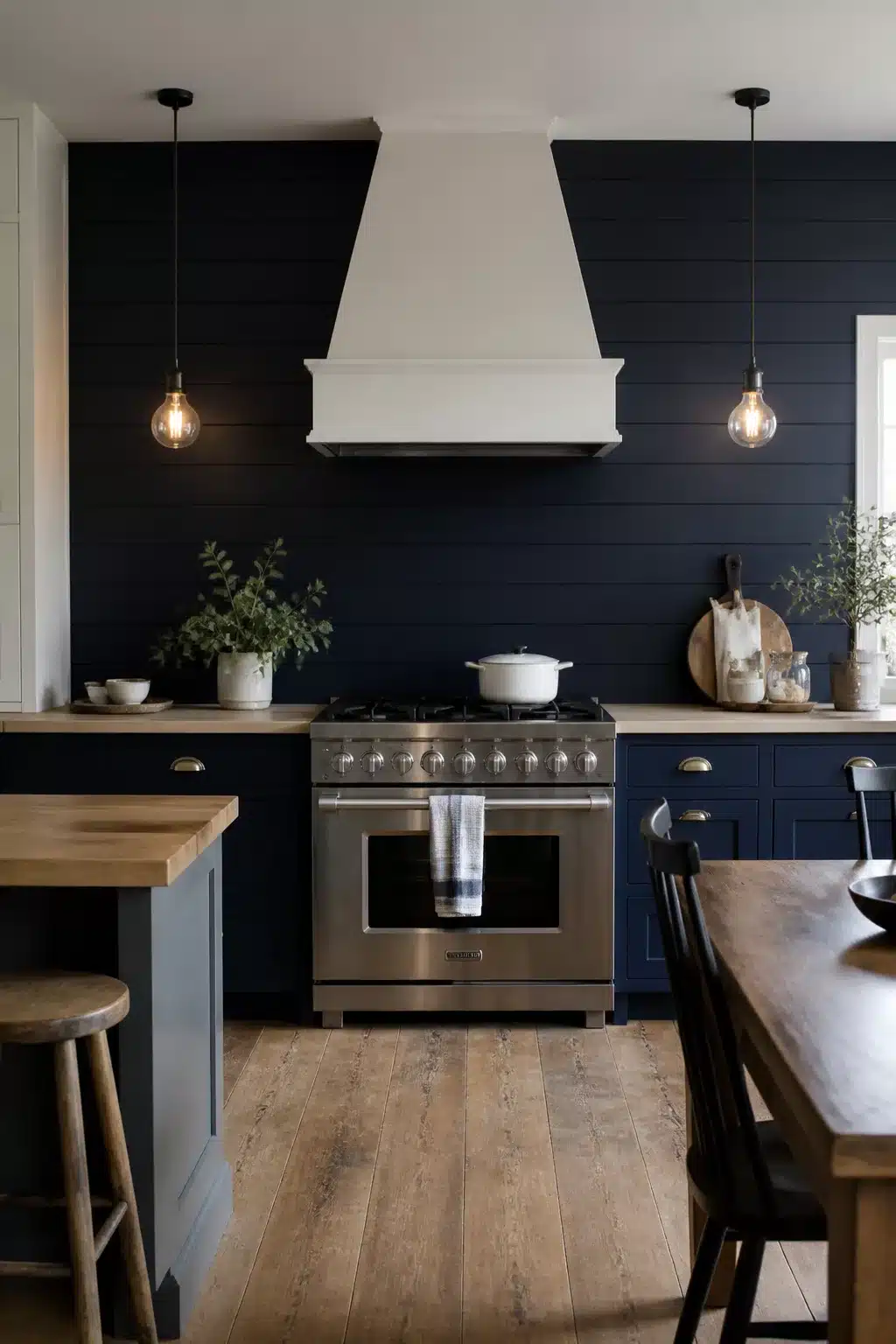Navy kitchen accent wall with shiplap boards, white range hood, brass hardware, and butcher block countertops