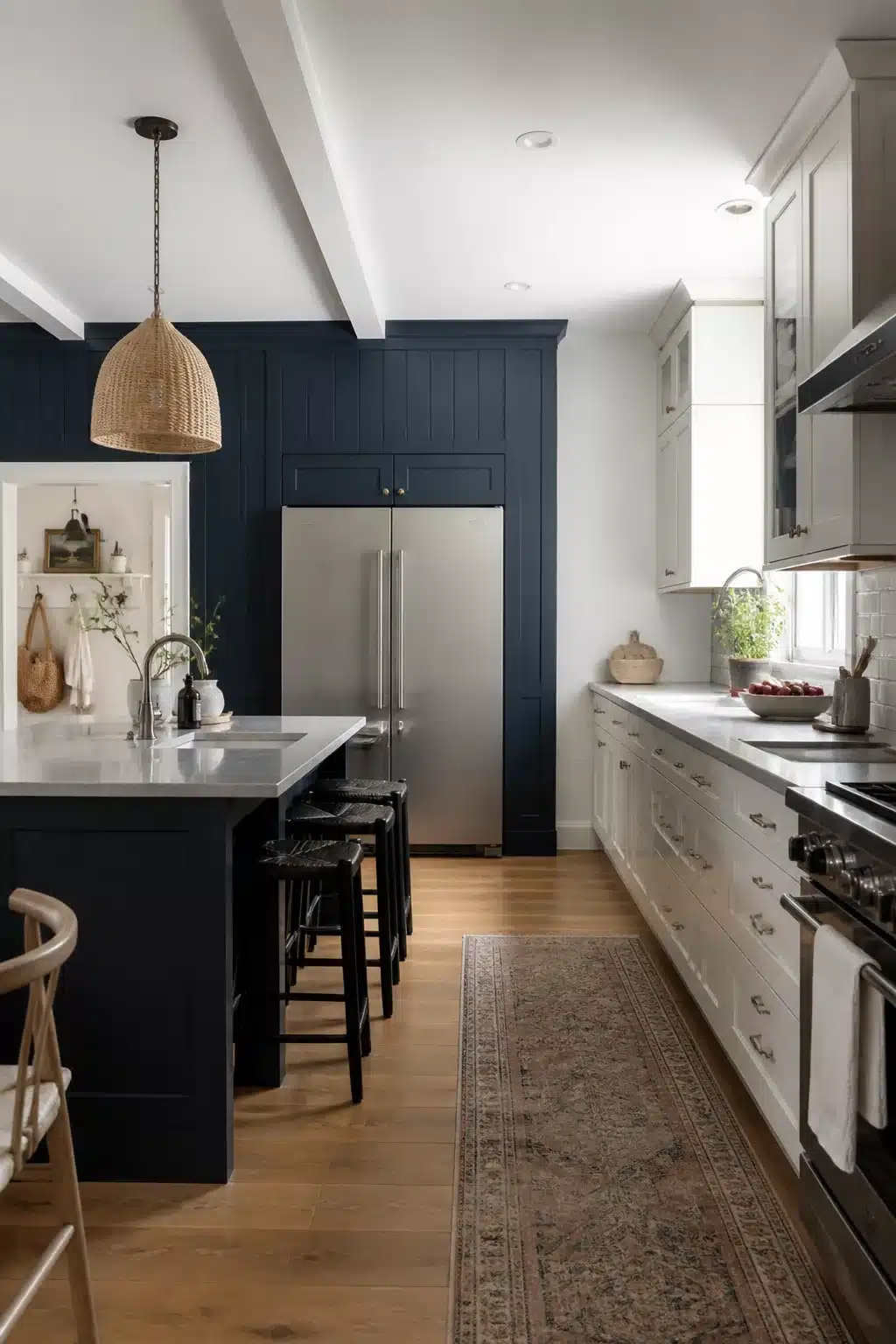 Navy kitchen accent wall with board-and-batten paneling framing a stainless fridge and matching navy island