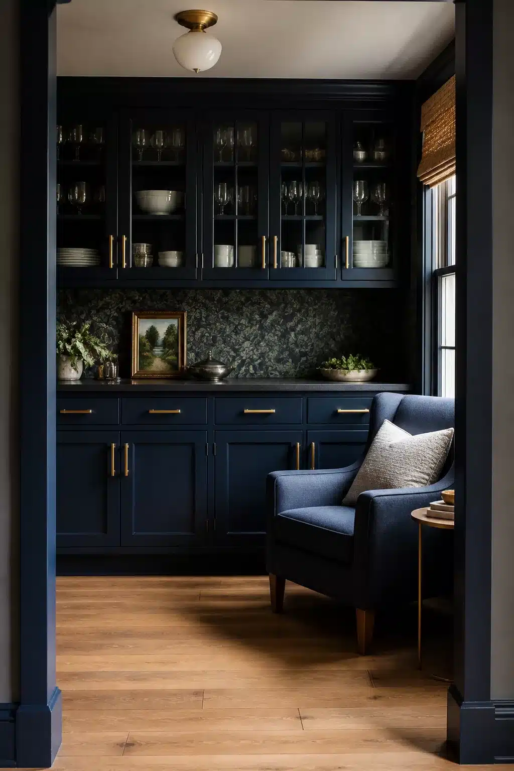Navy butler's pantry with brass bar handles, glass-front upper cabinets and botanical wallpaper — navy kitchens with brass handles