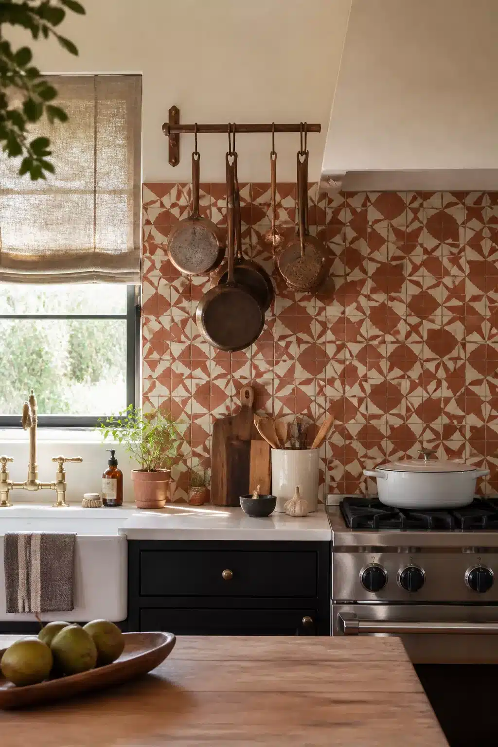 Terracotta kitchen backsplash with geometric encaustic cement tiles, copper pots, and dark cabinets