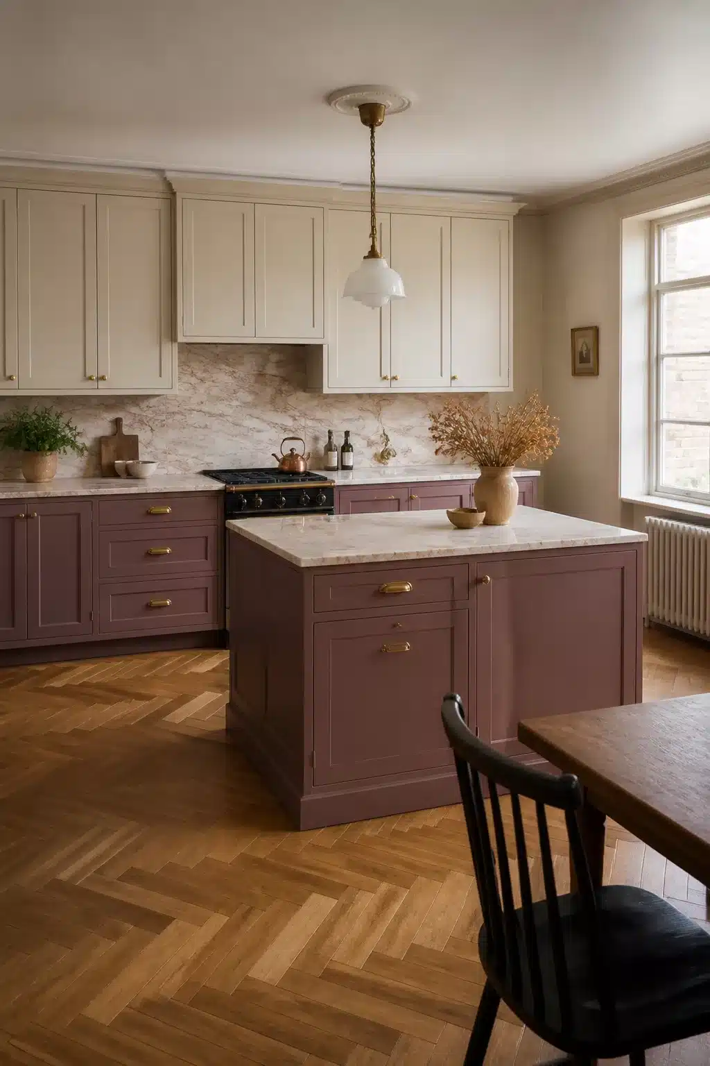 Two tone kitchen cabinet ideas with dusty mauve lowers, off-white uppers, brass hardware, and herringbone wood floor