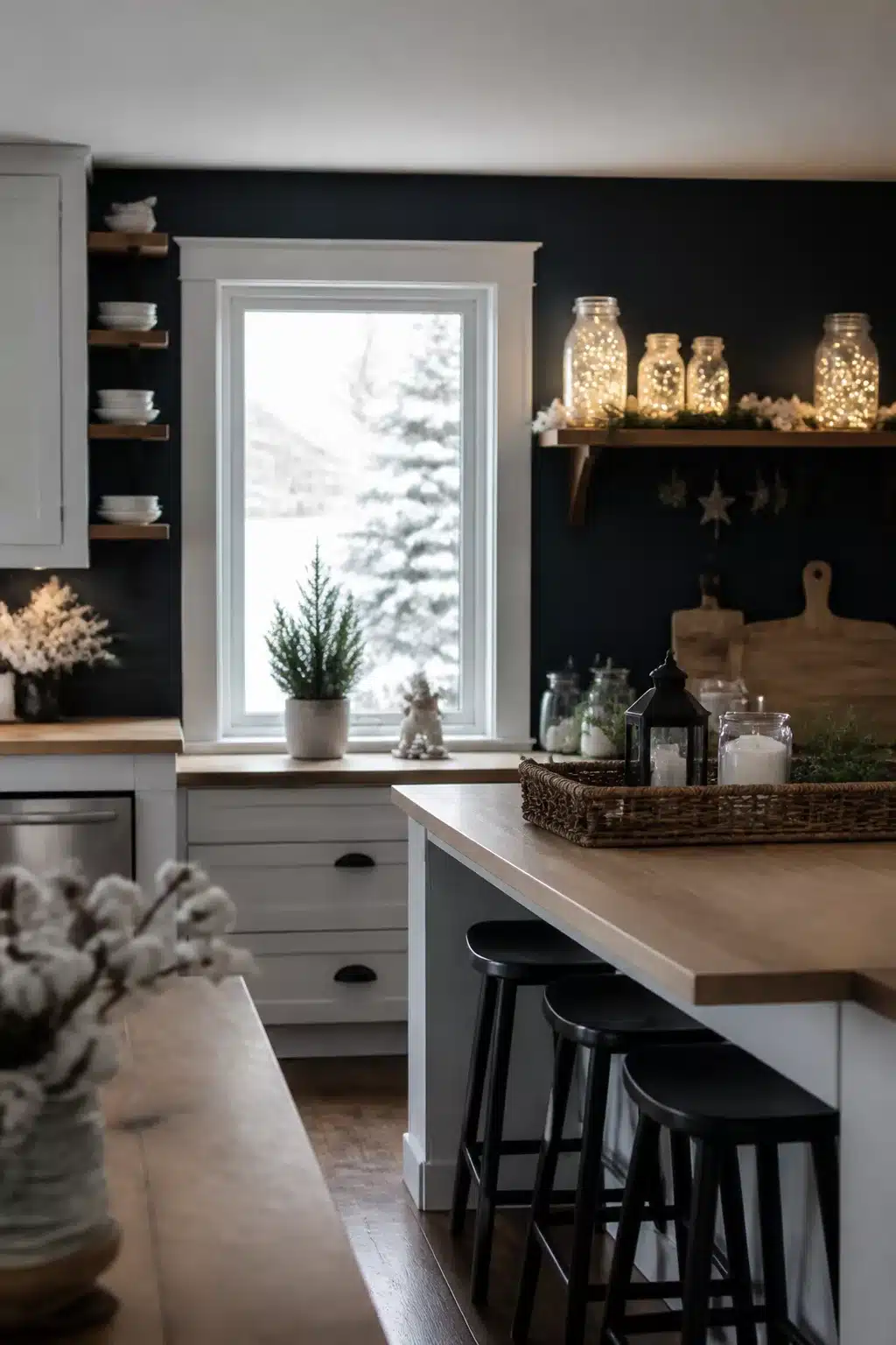 Winter kitchen decor ideas with mason jars filled with fairy lights on open wood shelves against navy walls