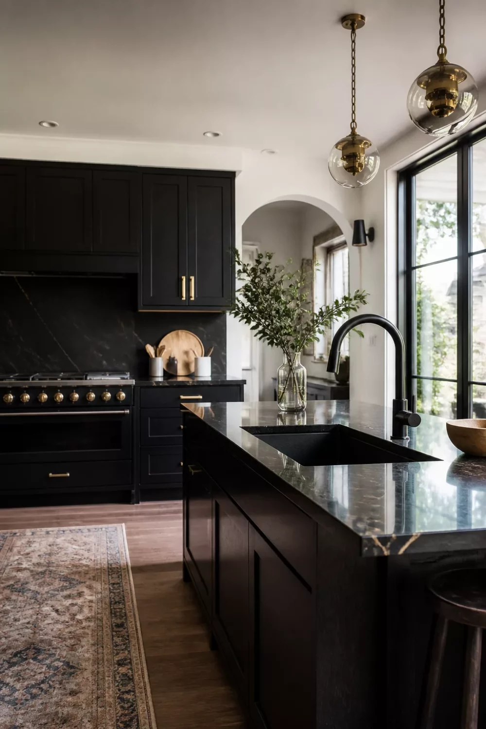 Glossy black kitchen faucet with dark marble island and black shaker cabinets — black kitchen faucet ideas