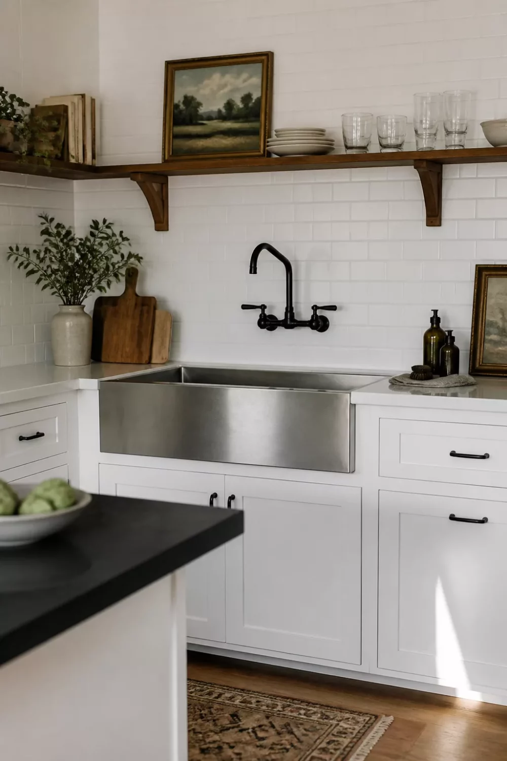 Black wall-mount kitchen faucet over stainless farmhouse sink with white subway tile backsplash — black kitchen faucets idea