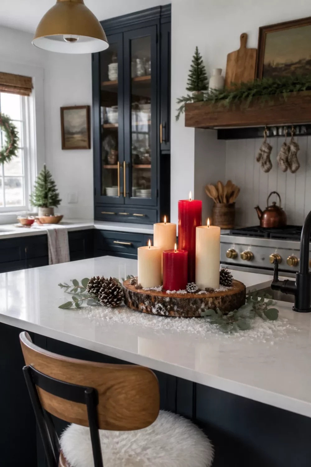 Christmas kitchen ideas with pillar candles on a live-edge wood slice centerpiece on a white quartz island