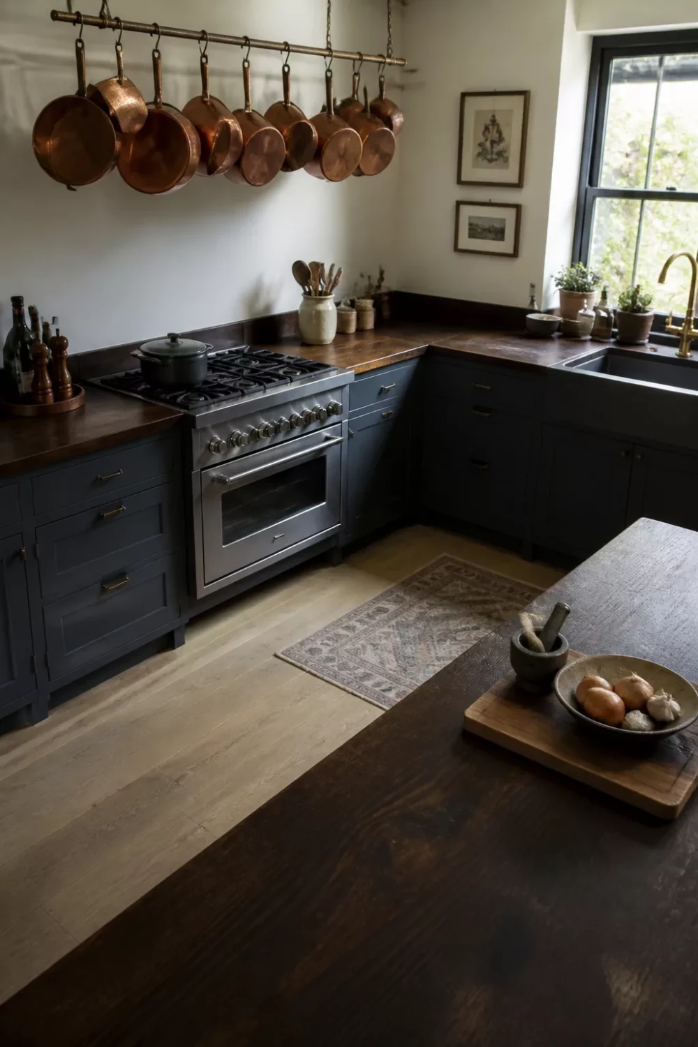Dark wood kitchen countertops wrapping an L-shaped layout with copper pot rail and stainless range.