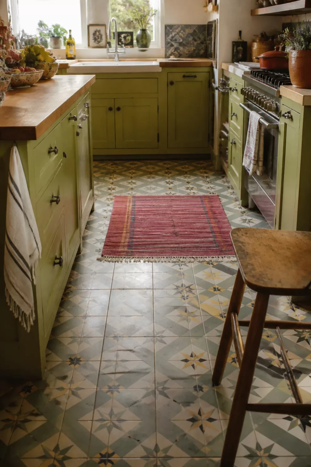 Chartreuse green kitchen with butcher block countertops, patterned star tile floor, and red kilim rug