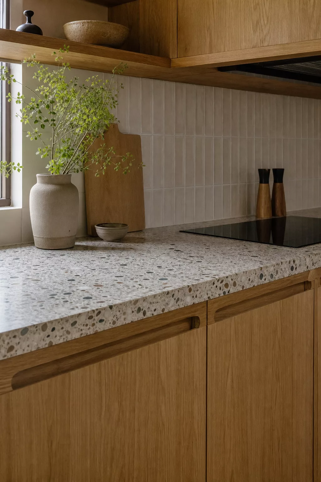 Speckled terrazzo counter and oak cabinets, a Japandi kitchen design idea