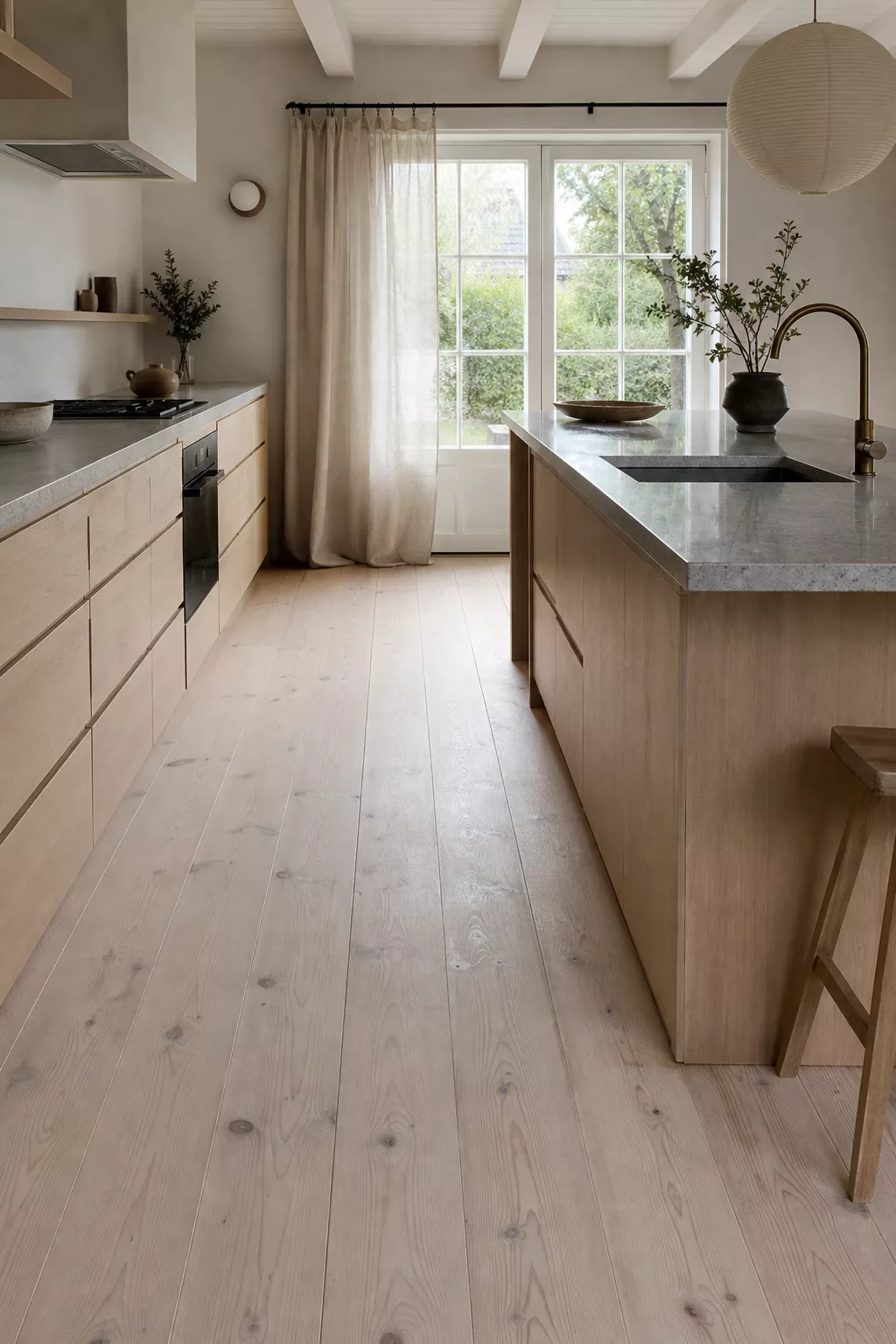 Whitewashed pine floorboards in a bright Japandi kitchen, a top pick for Japandi Kitchen Floor Ideas