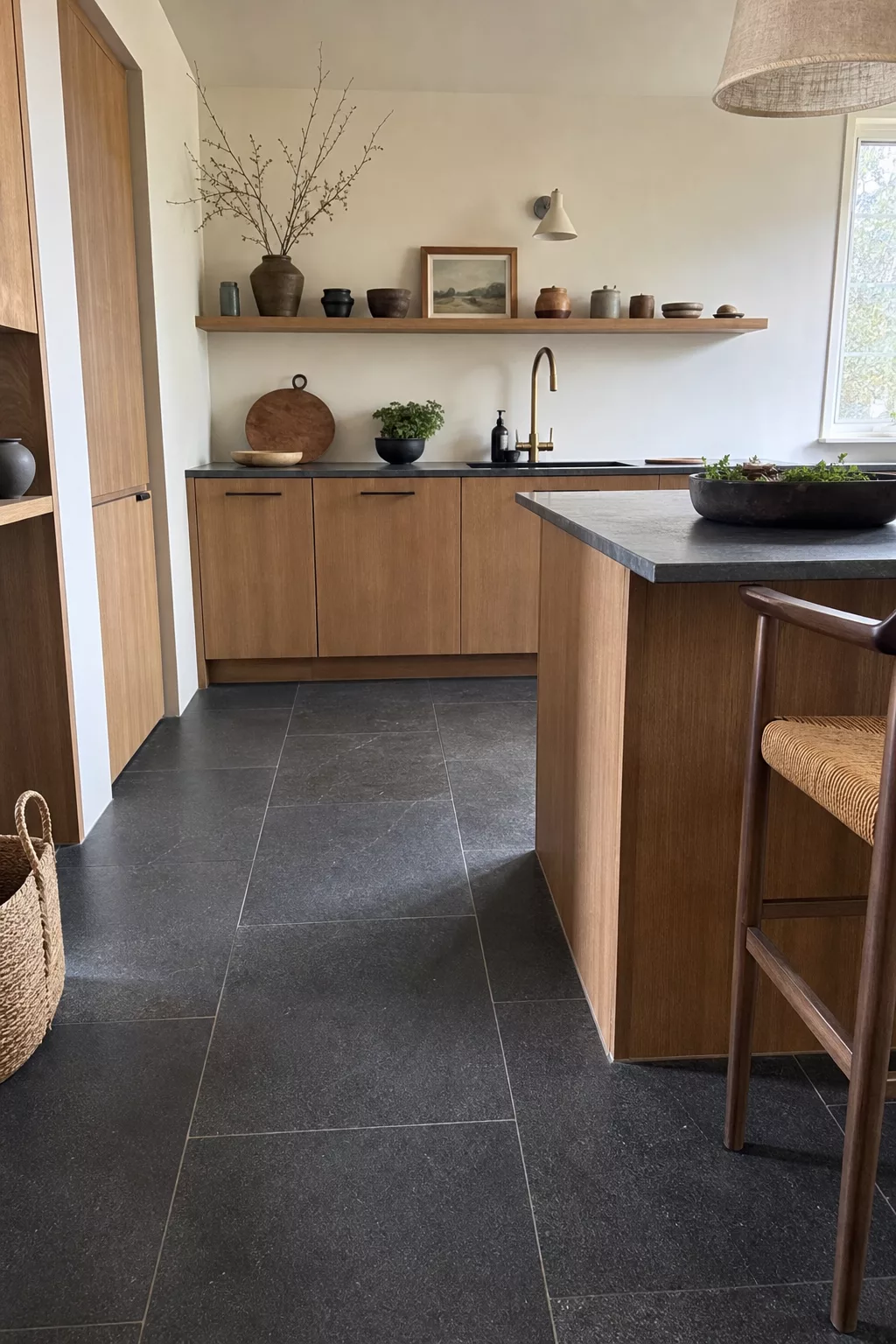 Japandi kitchen floor ideas featuring honed basalt stone tile flooring and oak cabinetry