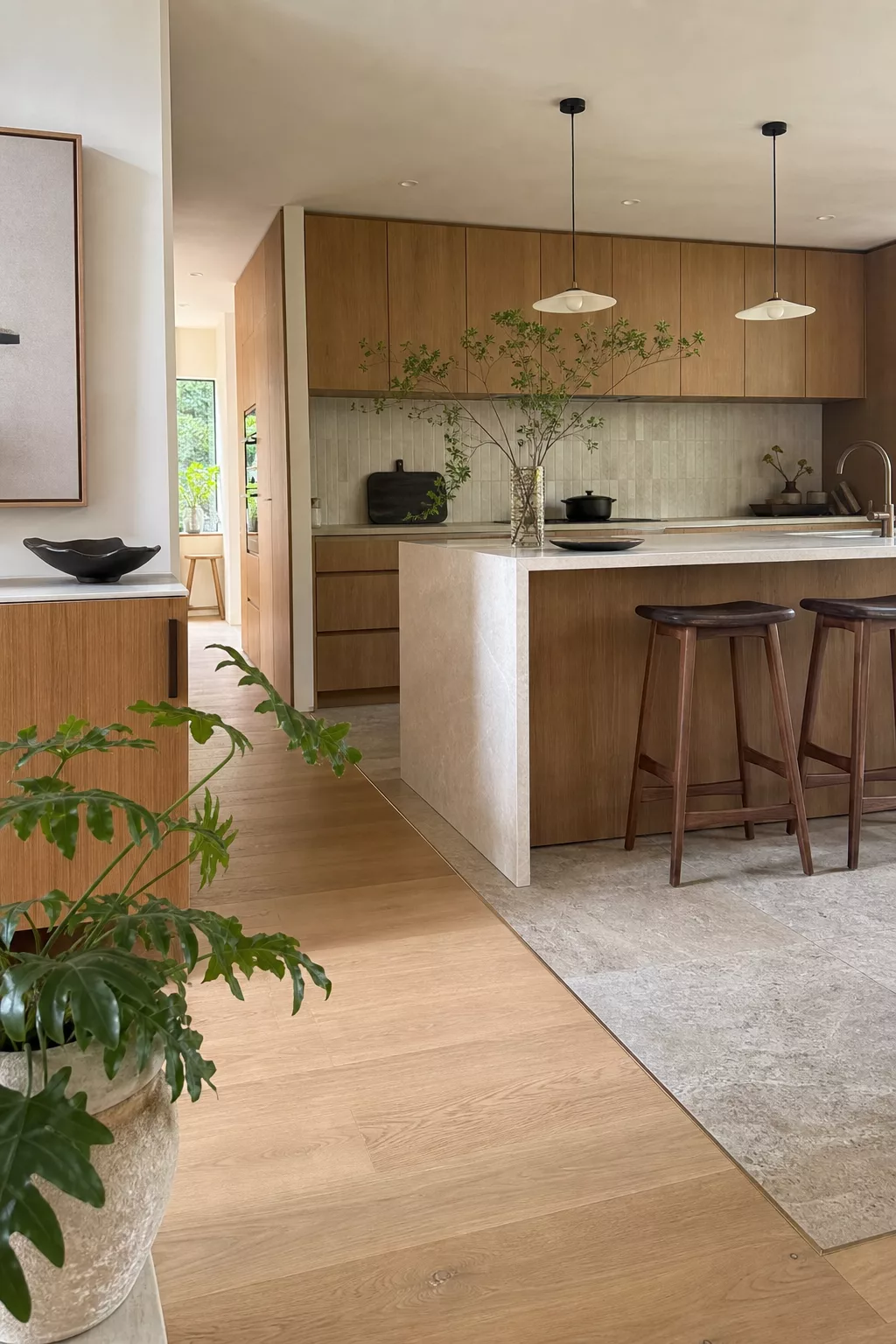 Japandi kitchen floor ideas shown with wood-to-stone tile zoning at the island