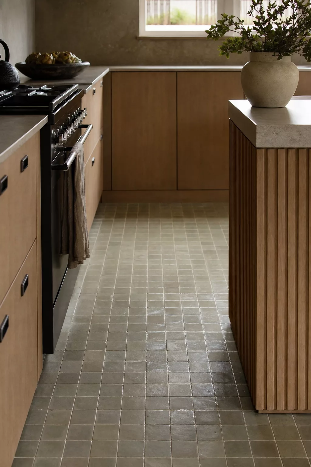 Handmade zellige-style tile floor in a Japandi kitchen with oak cabinetry