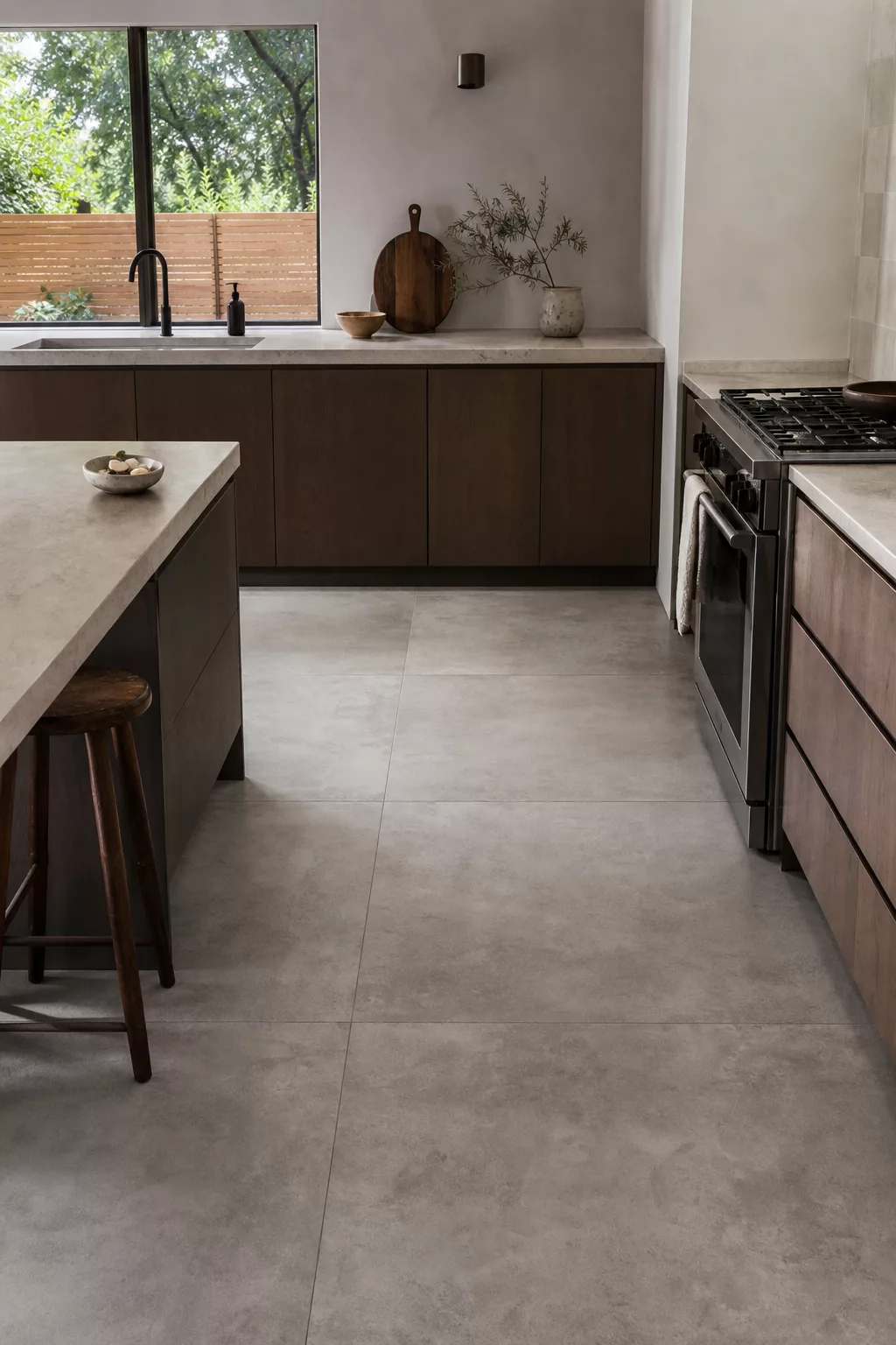 Japandi kitchen floor ideas with large-format concrete-look gray tile flooring