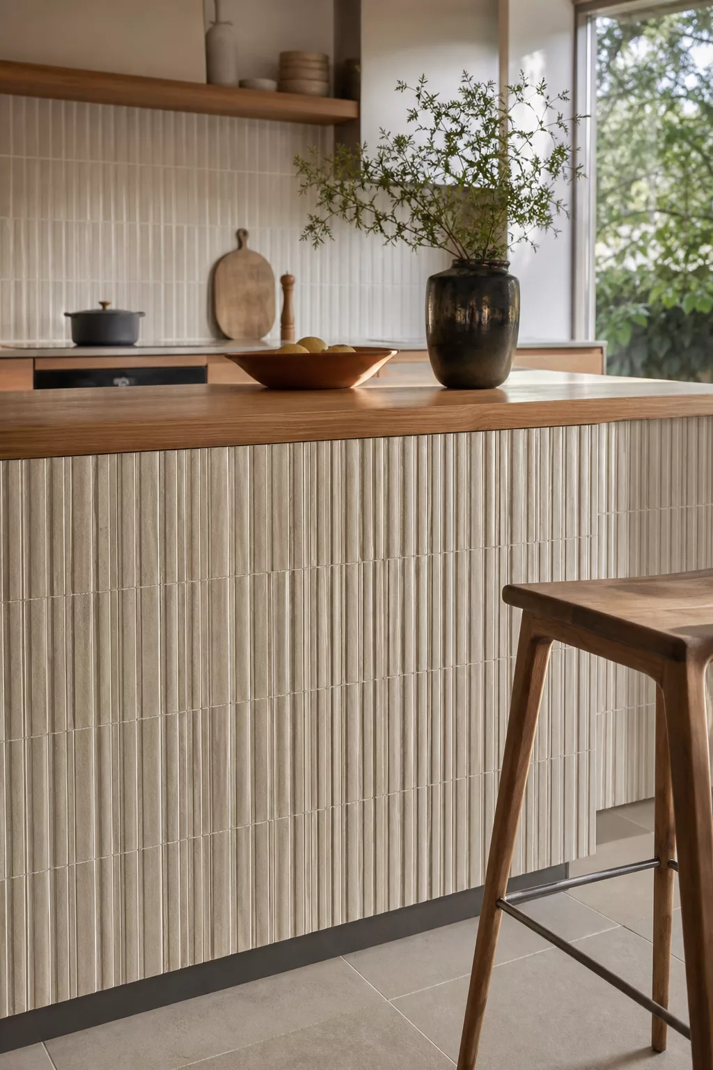 Japandi kitchen island with vertical fluted texture tile cladding and wood counter