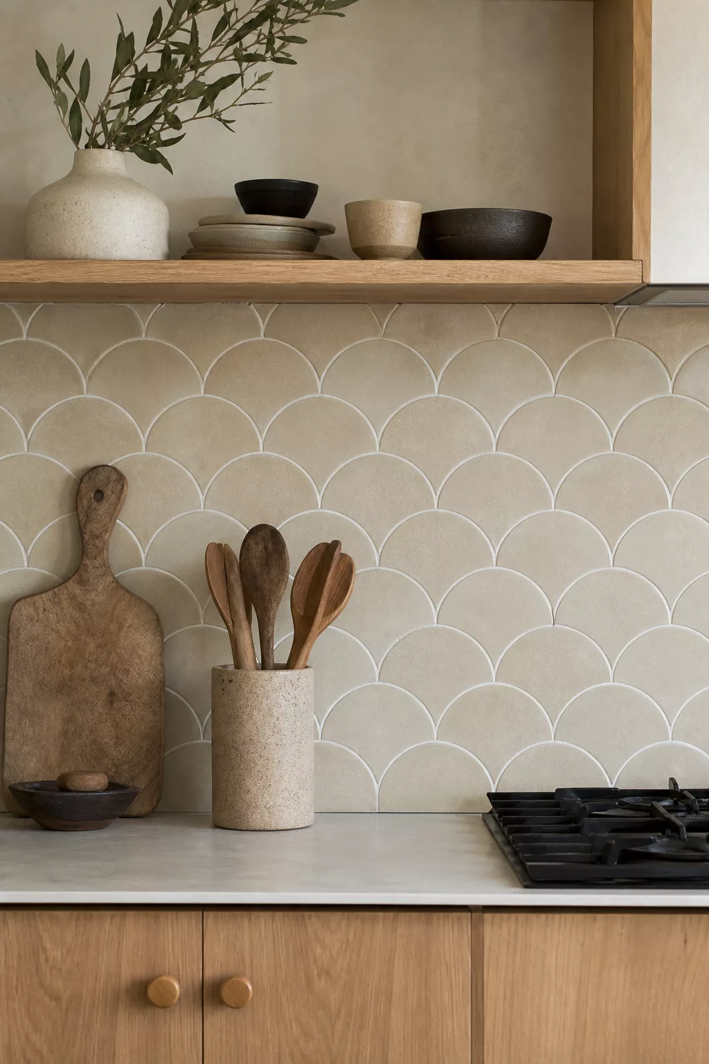 Warm beige scalloped Japandi kitchen tiles behind open wood shelving and gas cooktop