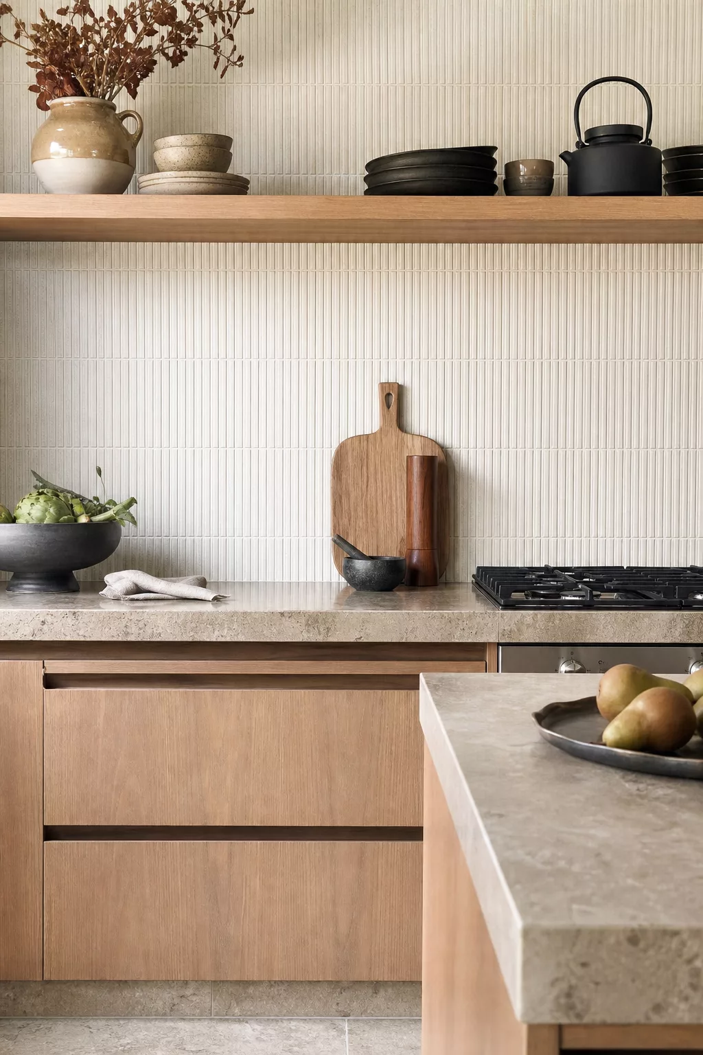 Cream fluted ribbed Japandi kitchen tiles behind wood shelf and stone counter