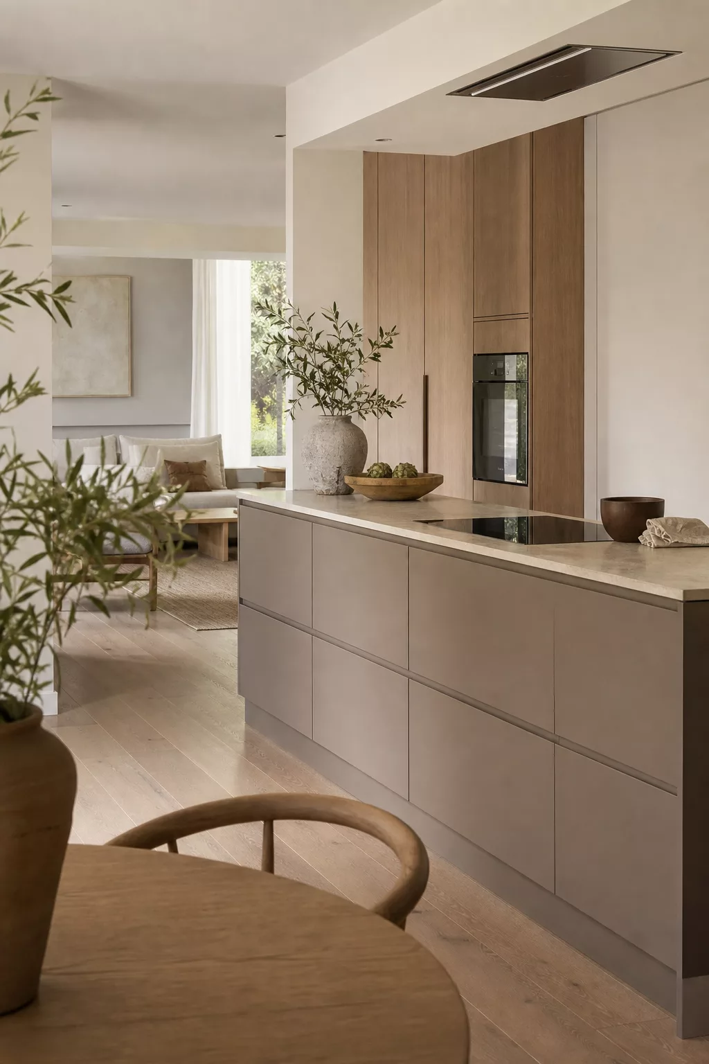 Japandi open kitchen design with matte taupe handleless cabinets and oak tall unit