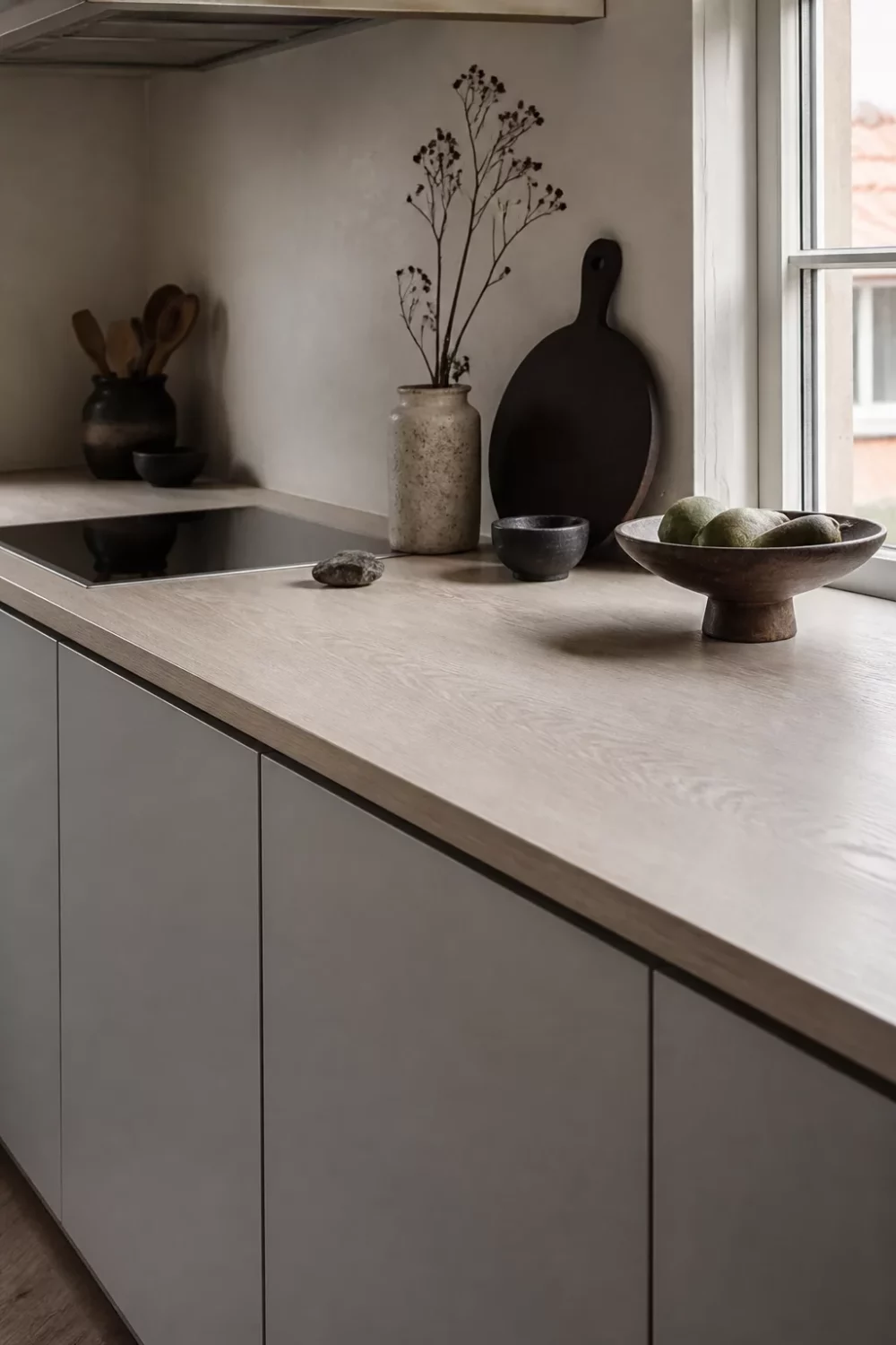Pale bleached ash wood kitchen countertop with handleless gray cabinets — minimalist wood kitchen countertops idea